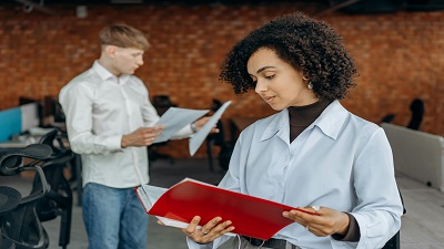 Jeune femme dans un bureau partagé avec des classeurs