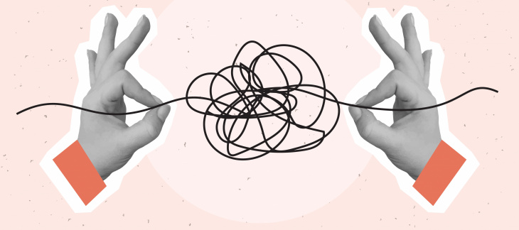 Deux mains tirant sur un fil emmêlé